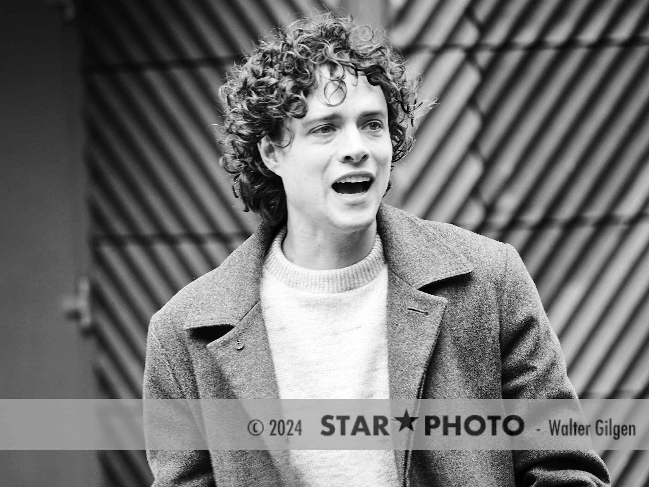 Actor Douglas Smith exits press conference behind Grand Hyatt hotel and encounters fans waiting for him.