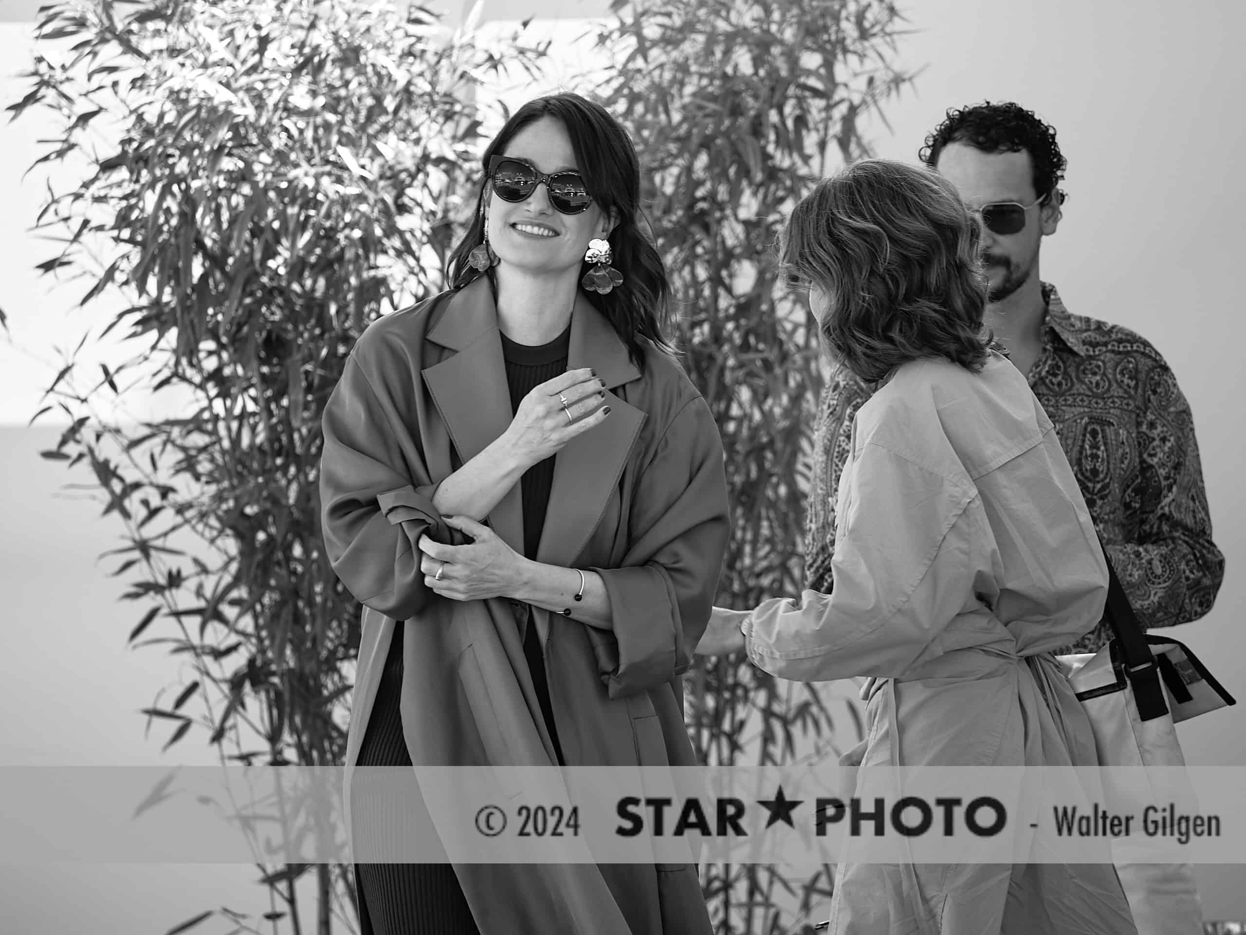 Actress Marie Gillain (left) at side entrance of Cannes festival center on the way to photo call.